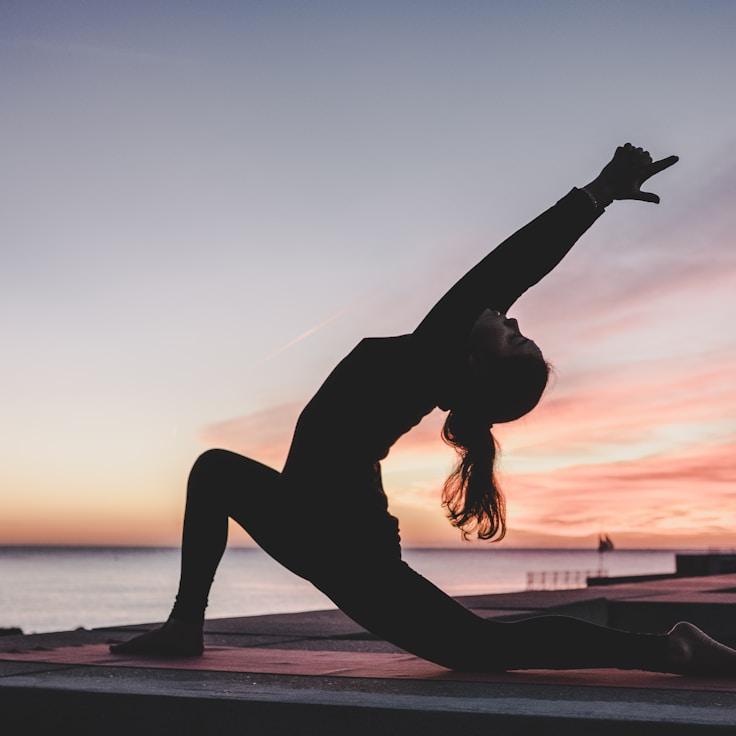 Women in a fitness class doing stretching and mobility exercises